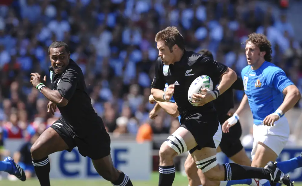 Richie McCaw carries the ball for the All Blacks